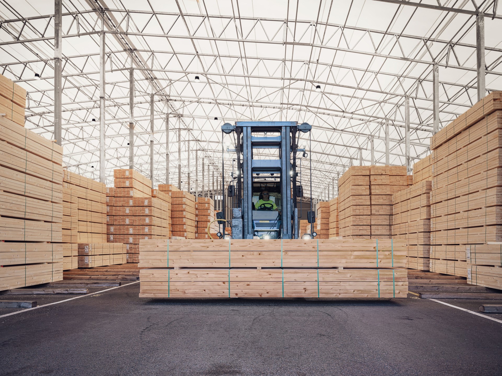 Stacks of timber in indoor storage, ready for loading